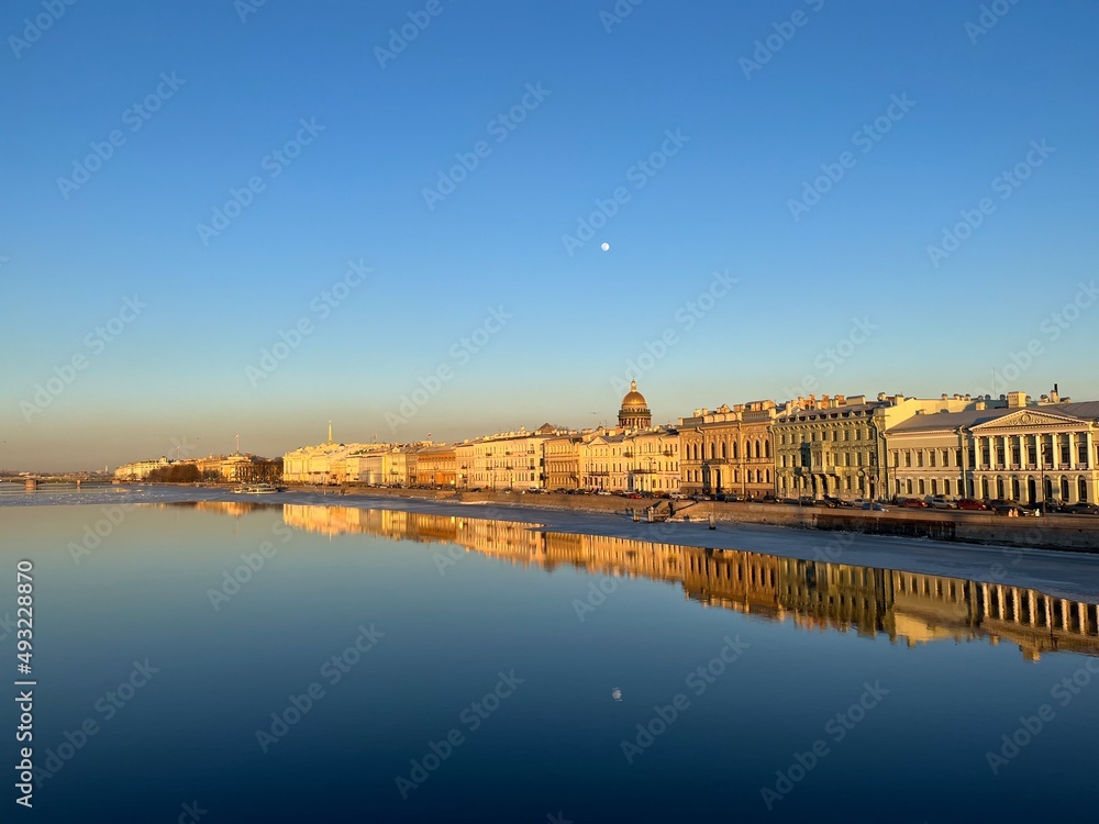 City river, blue sky, reflection on the water 
