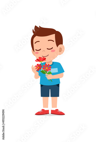 little boy holding flower and sniff the scent