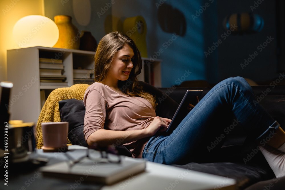 woman using digital tablet at home. relaxing on sofa at home woman using digital tablet at home. relaxing on sofa at home