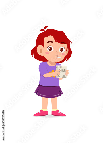 little girl drink a box of milk with straw
