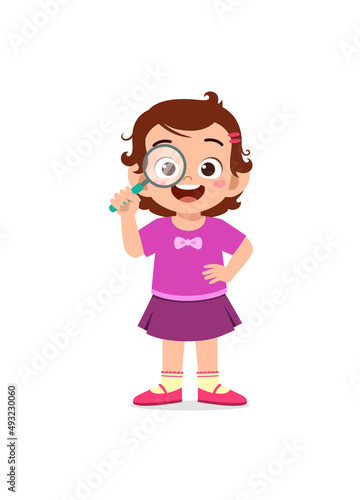 little girl standing and holding magnifying glass
