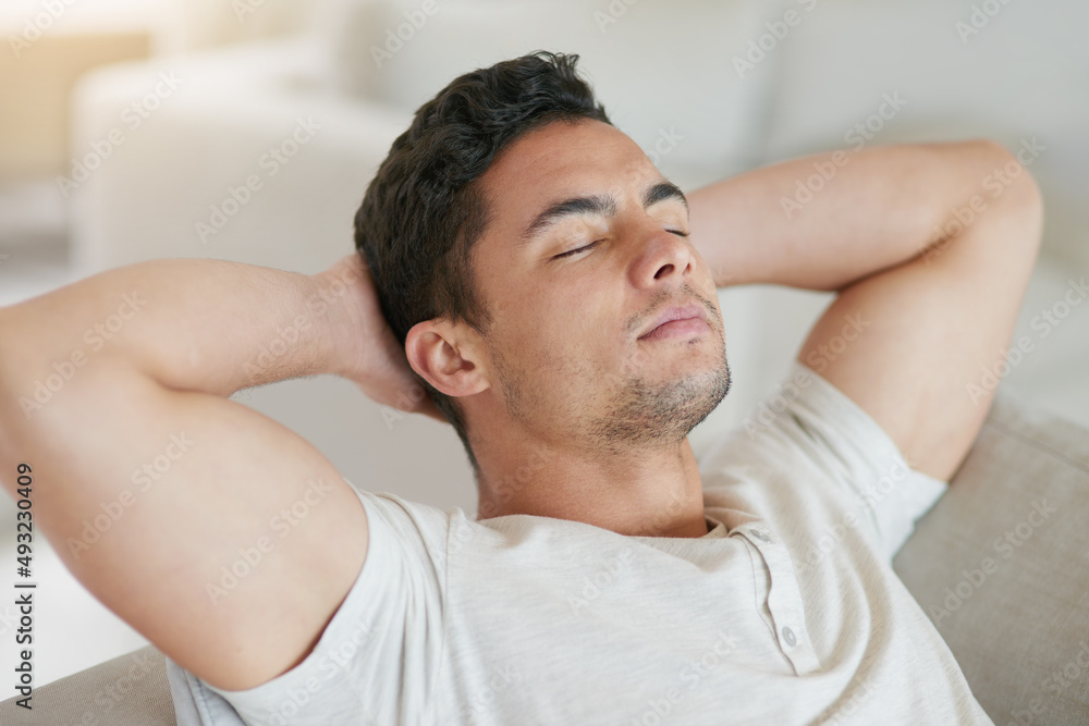 Ahhhweekend. Shot of a young man relaxing on the sofa at home. Ahhhweekend. Shot of a young man relaxing on the sofa at home.