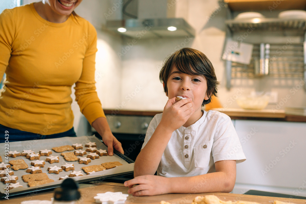 Fototapeta premium mother and son preparing food in kitchen
