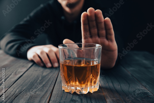 Man with a gesture refuses alcohol photo