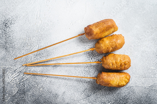 Homemade deep fried corn dogs. White background. Top view