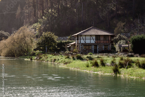 manor house on the banks of the river in the town of lekeitio in the basque country