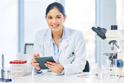 Modern medicine has advanced a long way. Portrait of a young scientist using a digital tablet in a lab.