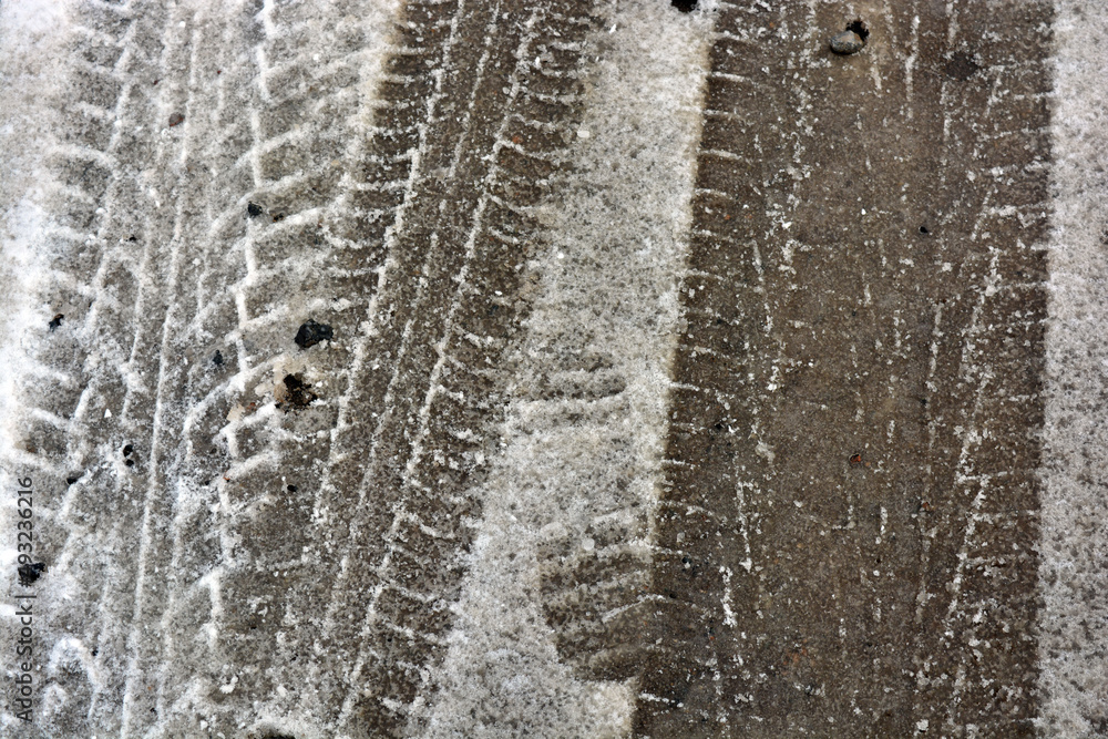 Tracks from car wheels, passing cars on a snowy and melting winter road, an interesting background. Tracks from car wheels, passing cars on a snowy and melting winter road, an interesting background.