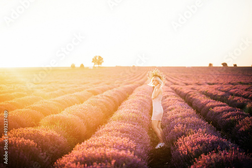 Beautiful teenage girl with a wreath of flowers and blonde hair, nose piercing. A teenager in a lavender field at sunset. Modern woman portrait