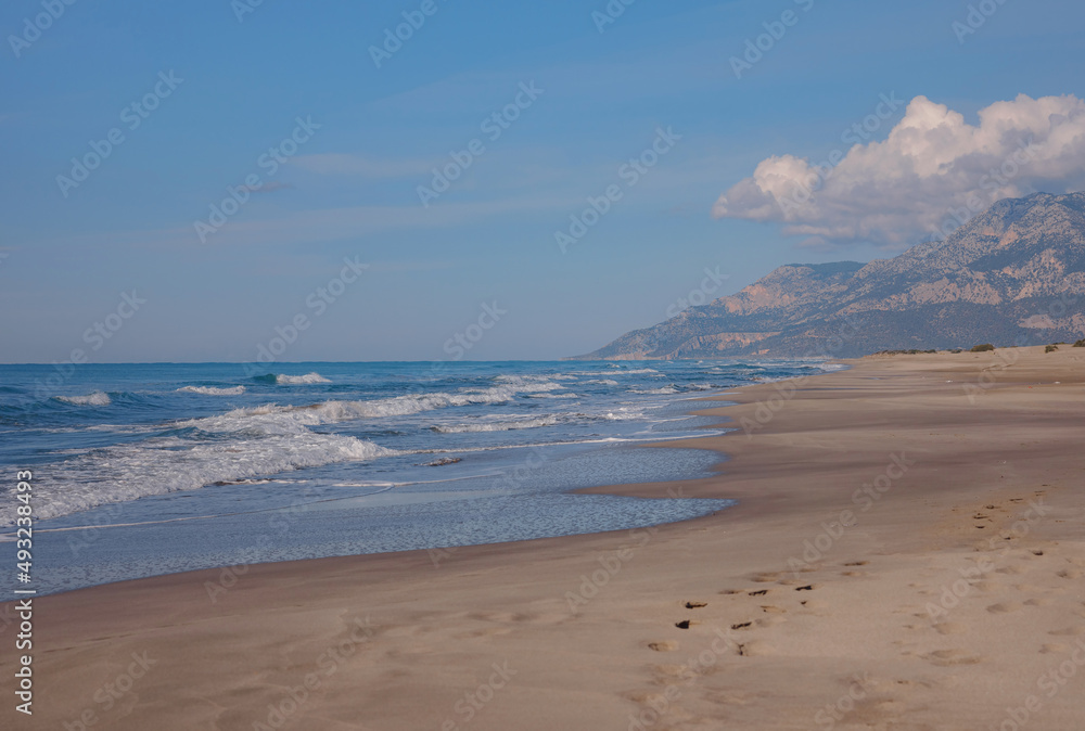 Patara beach is famous tourist landmark and natural destination in Turkey. Majestic view of orange sand dunes and hills glows