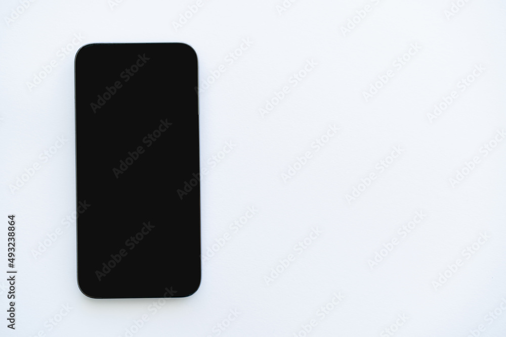 Top view of cellphone with blank screen on white background. Top view of cellphone with blank screen on white background.