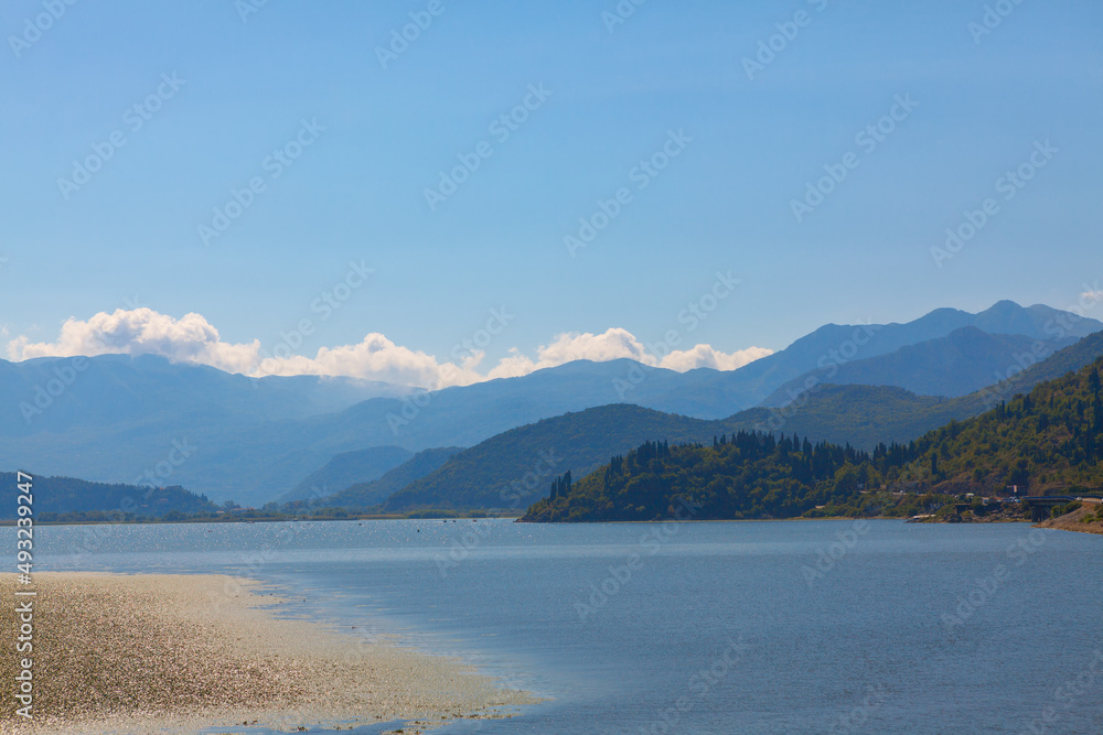 Blue mountains and lake landscape . Lake Skadar the largest lake in the Balkan Peninsula 