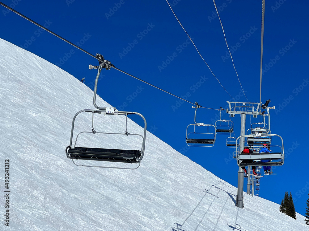 Chair lift at Ski Resort. Beautiful winter day with perfect sunny weather, clean blue sky. Chair lift at Ski Resort. Beautiful winter day with perfect sunny weather, clean blue sky.