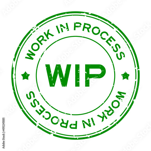 Grunge green WIP work in process word round rubber seal stamp on white background