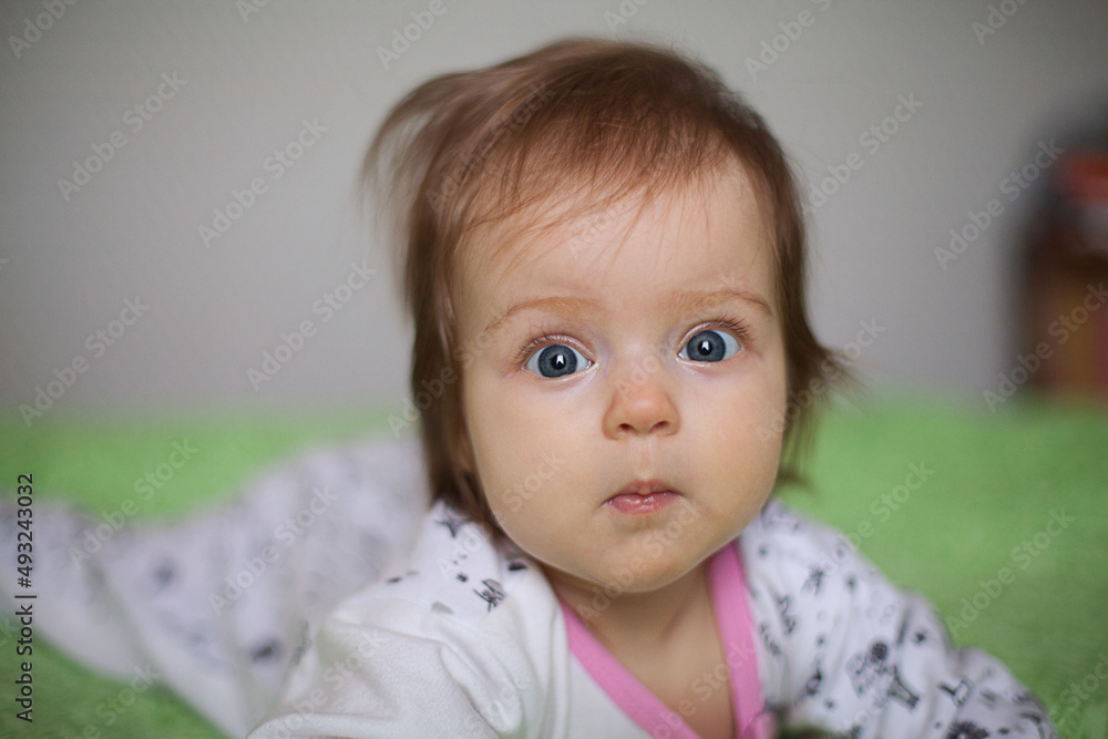 Little girl portrait at home. One-year-girl playing on floor Little girl portrait at home. One-year-girl playing on floor