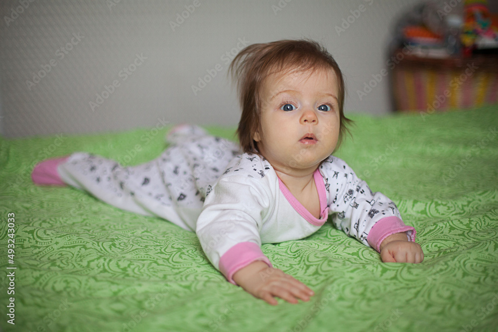 Fototapeta premium Little girl portrait at home. One-year-girl playing on floor