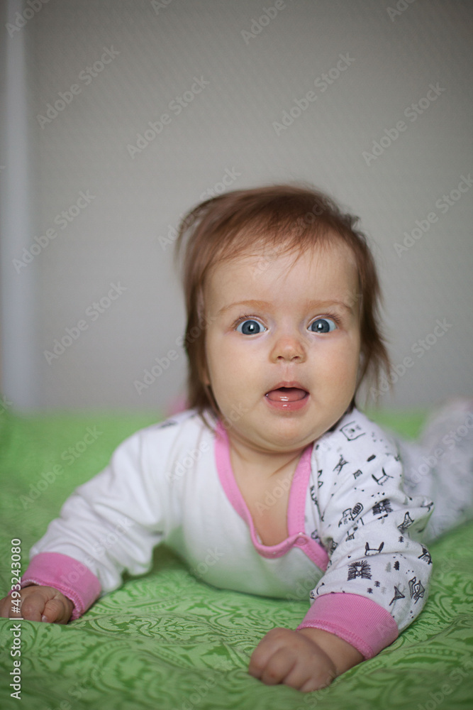 Little girl portrait at home. One-year-girl playing on floor Little girl portrait at home. One-year-girl playing on floor