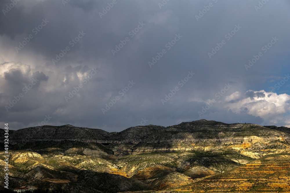 Landscape with rock formations, colorful mountains, cloudy sky.Turkey country	