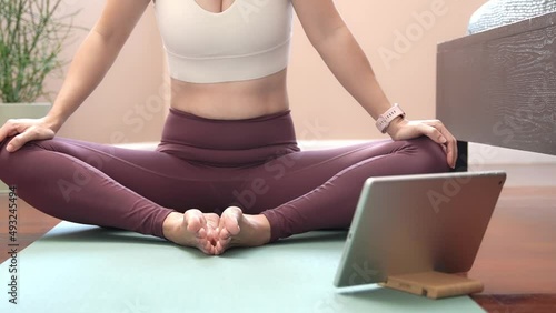 Stylish healthy Asian woman warm up hip flexor before practice yoga asana in bedroom at home. Online course, Relaxation exercise, Wellbeing, Trend, Weight loss, Stretch, Active lifestyle.