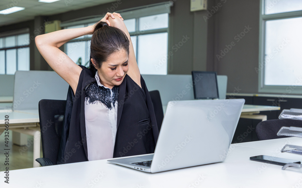 Young Businesswoman stretching with her arms in office. Young Businesswoman stretching with her arms in office.