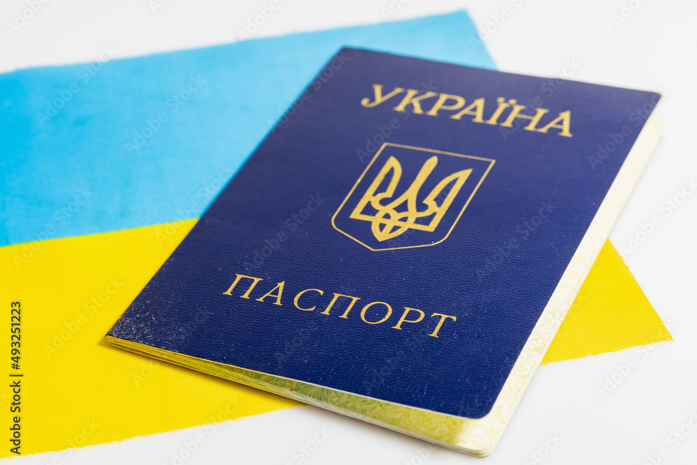 Ukrainian passport on the background of the flag of Ukraine. Isolated on a white background Ukrainian passport on the background of the flag of Ukraine. Isolated on a white background