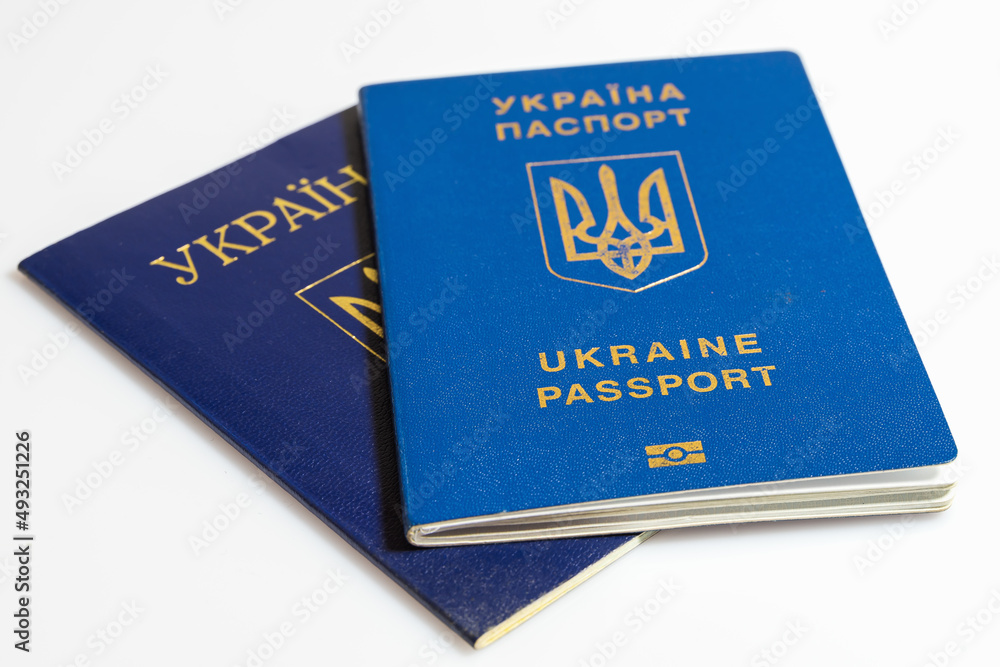 Ukrainian passport on background of Ukrainian flag. Isolated on a white background Ukrainian passport on background of Ukrainian flag. Isolated on a white background