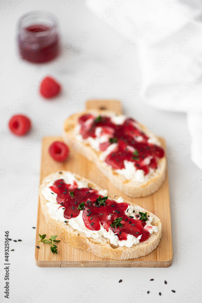 two sandwiches with raspberry jam and curd cheese two sandwiches with raspberry jam and curd cheese