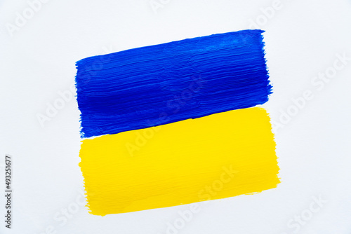 Top view of painted ukrainian flag on white background.