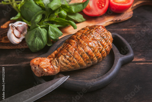 Artisan ham made from turkey meat, boiled and smoked with the addition of chicken fillet. Still life with ham in the form of a turkey leg