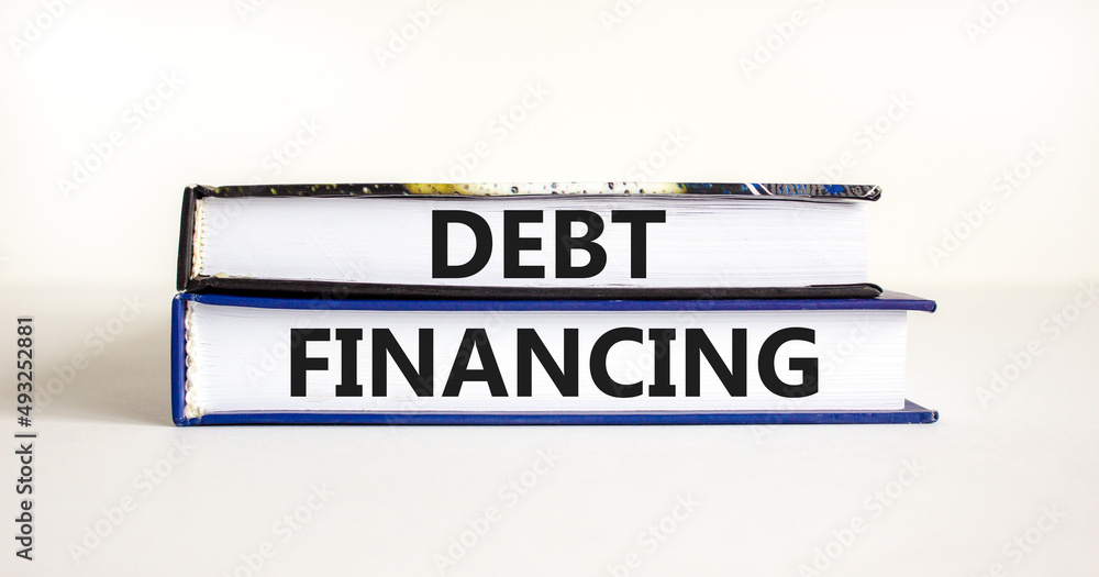 Debt financing symbol. Concept words Debt financing on books on a beautiful white table white background. Business finance and debt financing concept, copy space.