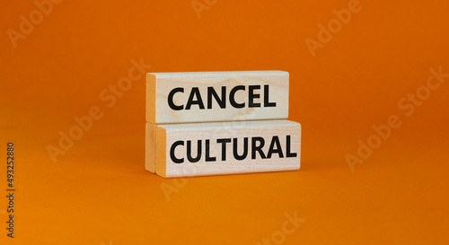 Cancel cultural symbol. Concept words Cancel cultural on wooden blocks on a beautiful orange table orange background. Business and cancel cultural concept, copy space. photo