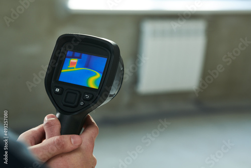 thermal imaging camera inspection for temperature check and finding heating pipes in floor photo