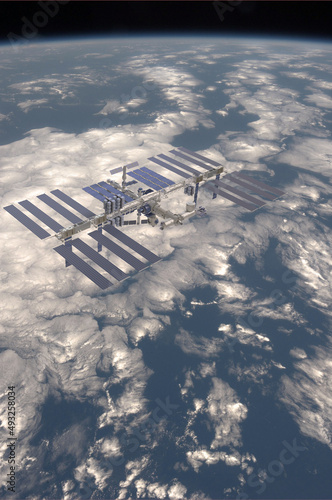 illustration of the International Space Station, ISS, with the planet earth in the background for web articles,posters etc. (ID: 493258034)