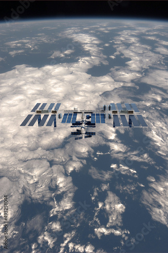 illustration of the International Space Station, ISS, with the planet earth in the background for web articles,posters etc. (ID: 493258044)