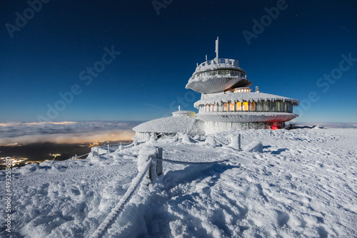 Winter view of the Meteorological Observatory on Śnieżka in the Karkonosze Mountains. The night landscape looks like it's on another planet. photo