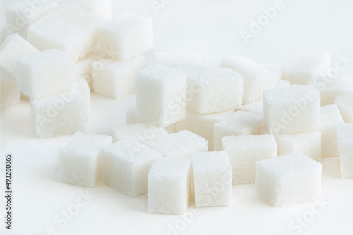 Sugar cubes isoalted on a white background. Heap of white sugar. Cubes of white sugar