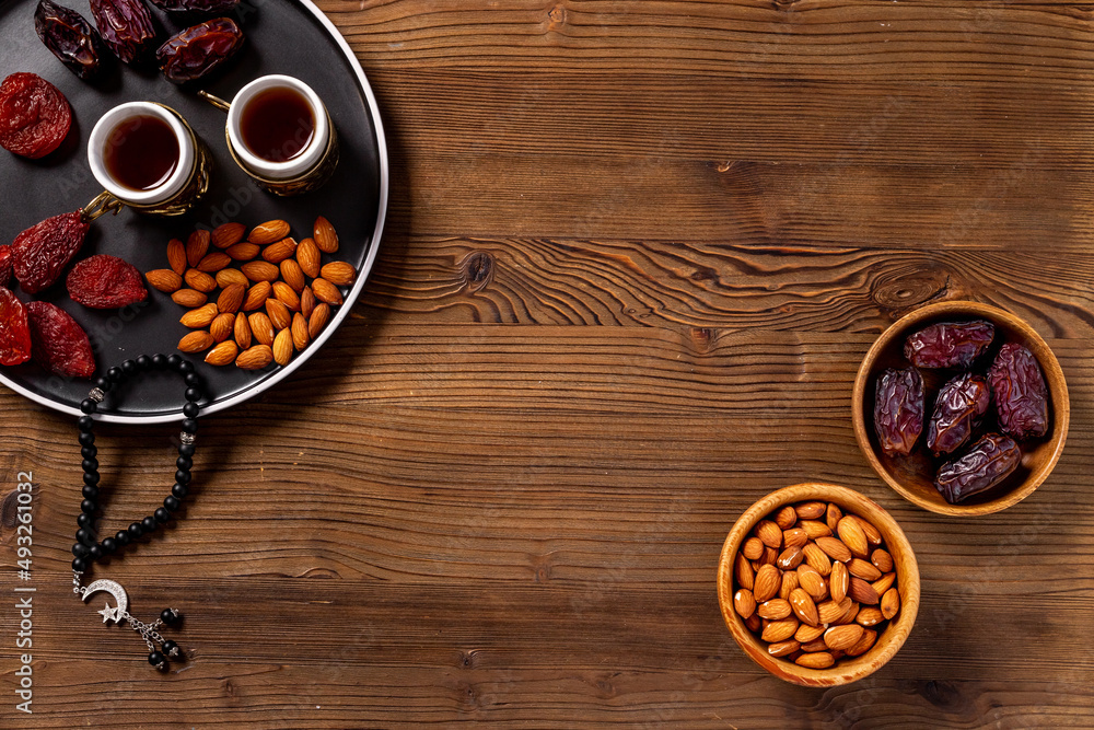Ramadan Kareem concept. Islamic rosary with star and crescent and dates fruits