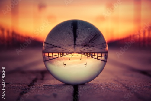 Abstract colorful holiday concept. Reflection of the pier in Gdynia  Poland on a glass ball.