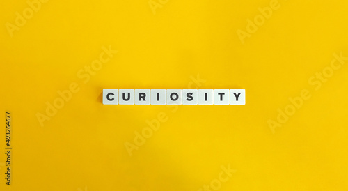 Tableau sur toile Curiosity Word on Letter Tiles on Yellow Background