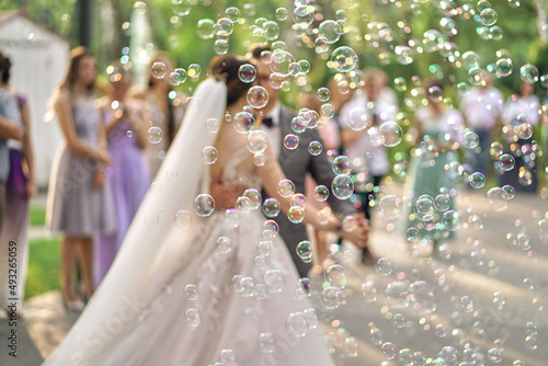 Soap bubbles blurred in the background of the bride