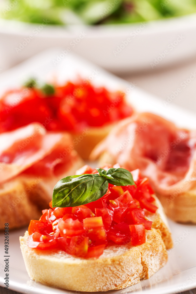Italian appetizer bruschetta with Parma ham on a plate Italian appetizer bruschetta with Parma ham on a plate