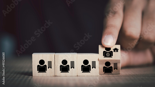 Hybrid workplace schedule, Gig economy, Freelance, Online business network communication, teamwork, home office concept. Hand flip wooden cube  icon of gig economy, copy space for background or text. photo