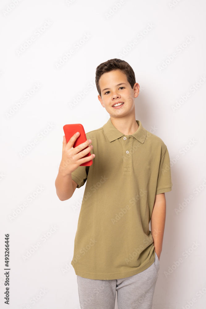 Caucasian boy in green polo shirt using smartphone isolated over white background. Caucasian boy in green polo shirt using smartphone isolated over white background.
