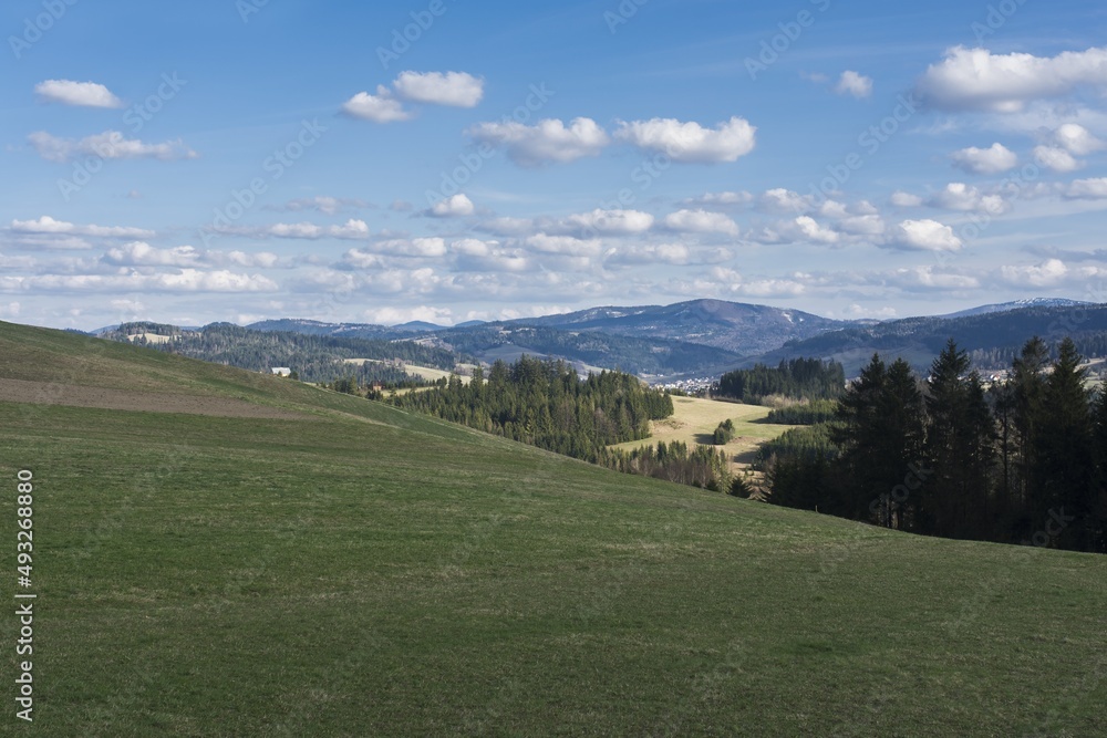 Landscape photography, image Czech Republic. Beskydy, Hrčava. Meadow, in the middle of the woods and mountains, in the background sky with clouds.