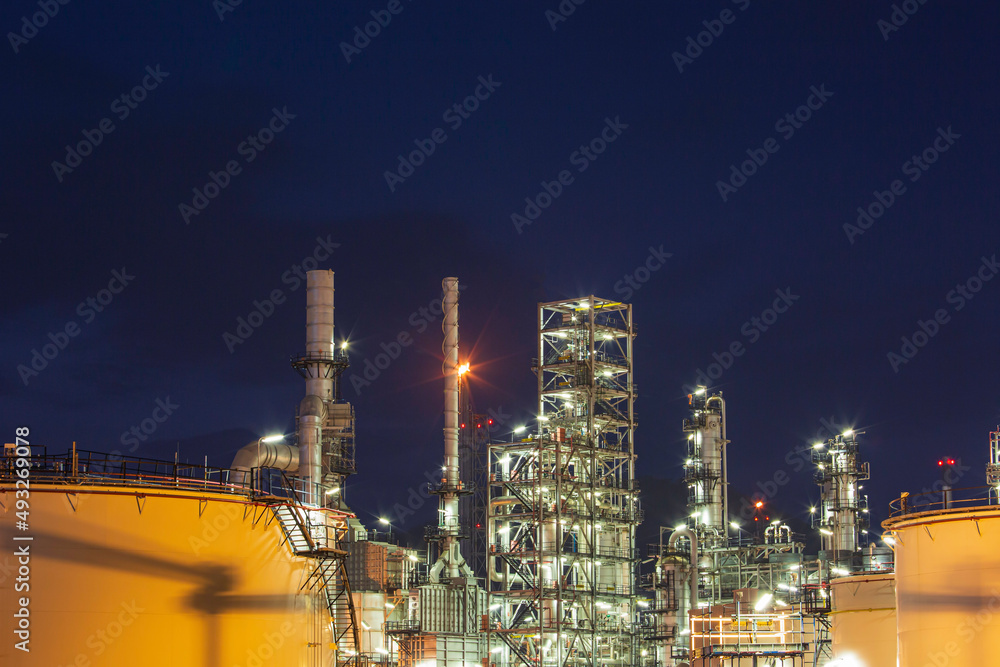 Fototapeta premium Twilight scene of tank oil refinery plant and tower column of Petrochemistry industry
