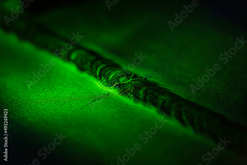 Crack steel butt weld carbon background green contrast magnetic filed photo