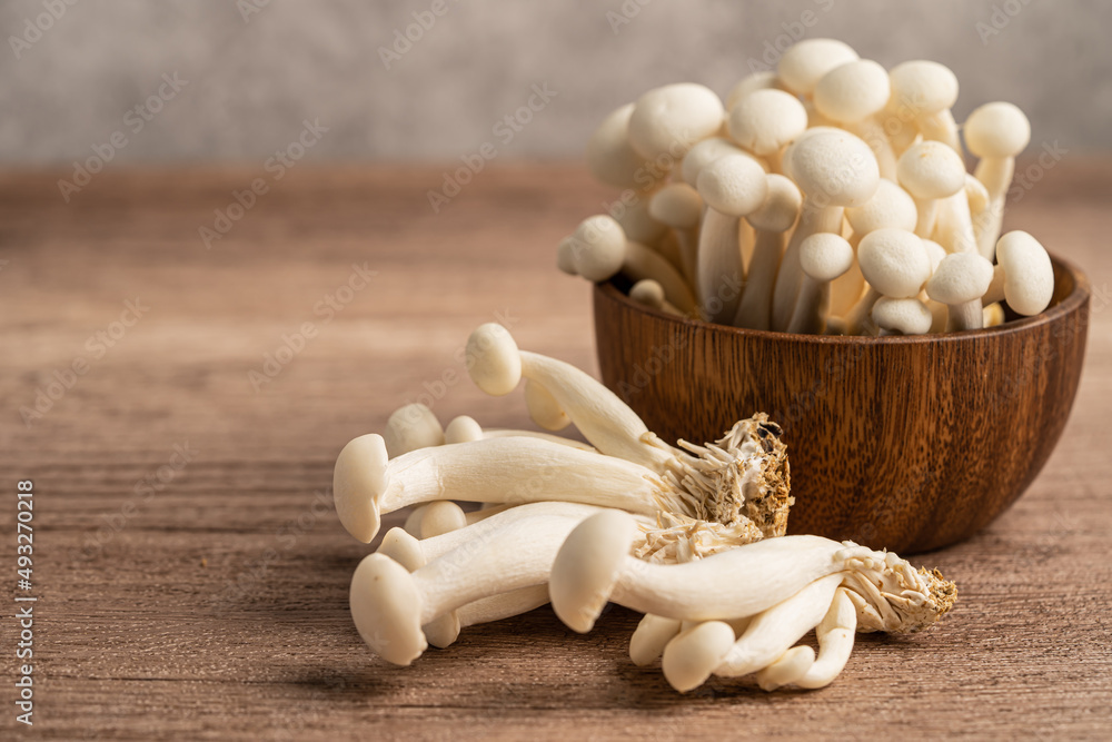 Shimeji, Fresh white bunapi mushrooms from Asia in wooden bowl. Shimeji, Fresh white bunapi mushrooms from Asia in wooden bowl.