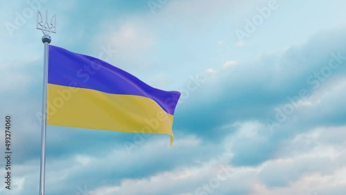 flag of Ukraine flutters in the wind against the backdrop of a dramatic sunset sky