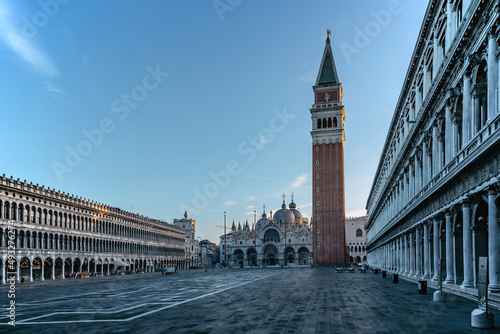 Famous empty San Marco square with Basilica of Saint Mark and Bell Tower at sunrise,Venice,Italy.Early morning at popular tourist destination.World famous Venice landmarks.Postcard view,travel scenery © Eva