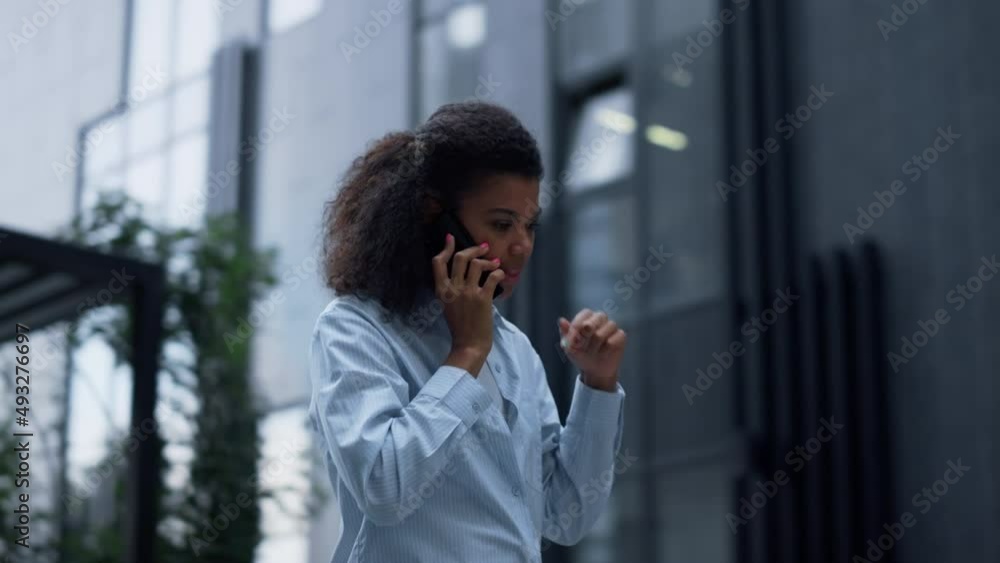 Focused business woman speaking mobile at modern building. Confident manager Focused business woman speaking mobile at modern building. Confident manager